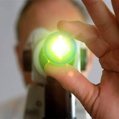 Man Holding onto a Green Retina Scan